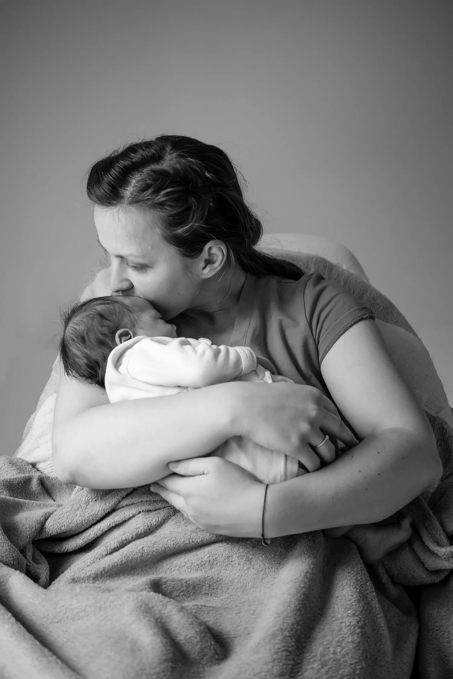 A mother holding her newborn close