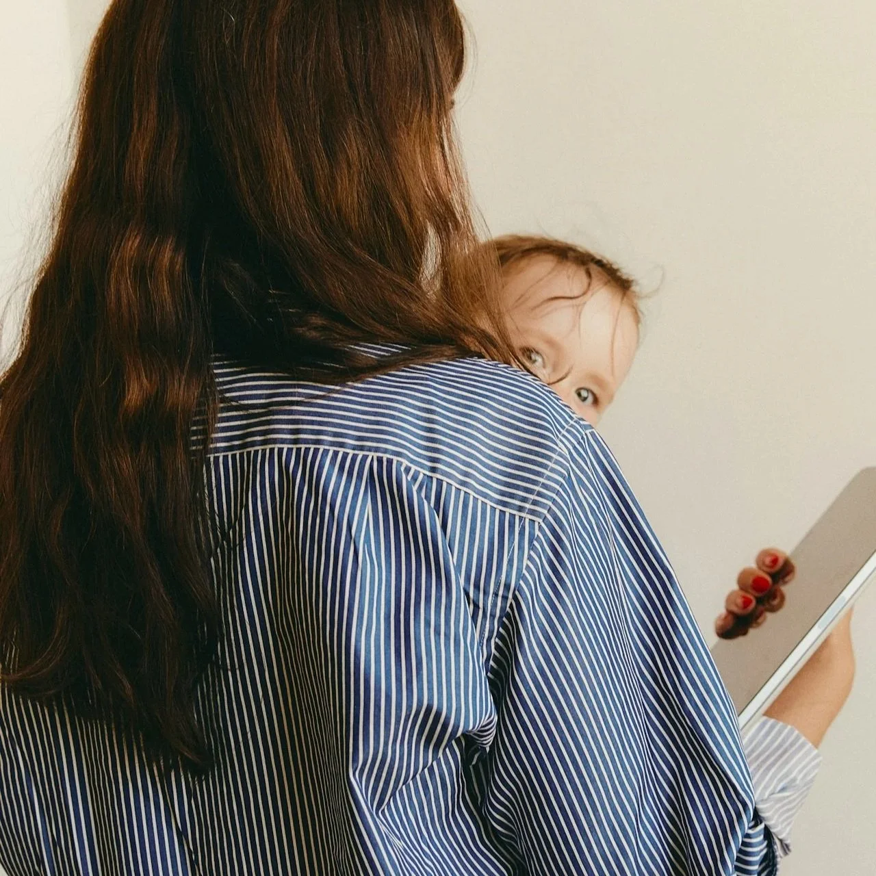 A mother at home with her baby and phone