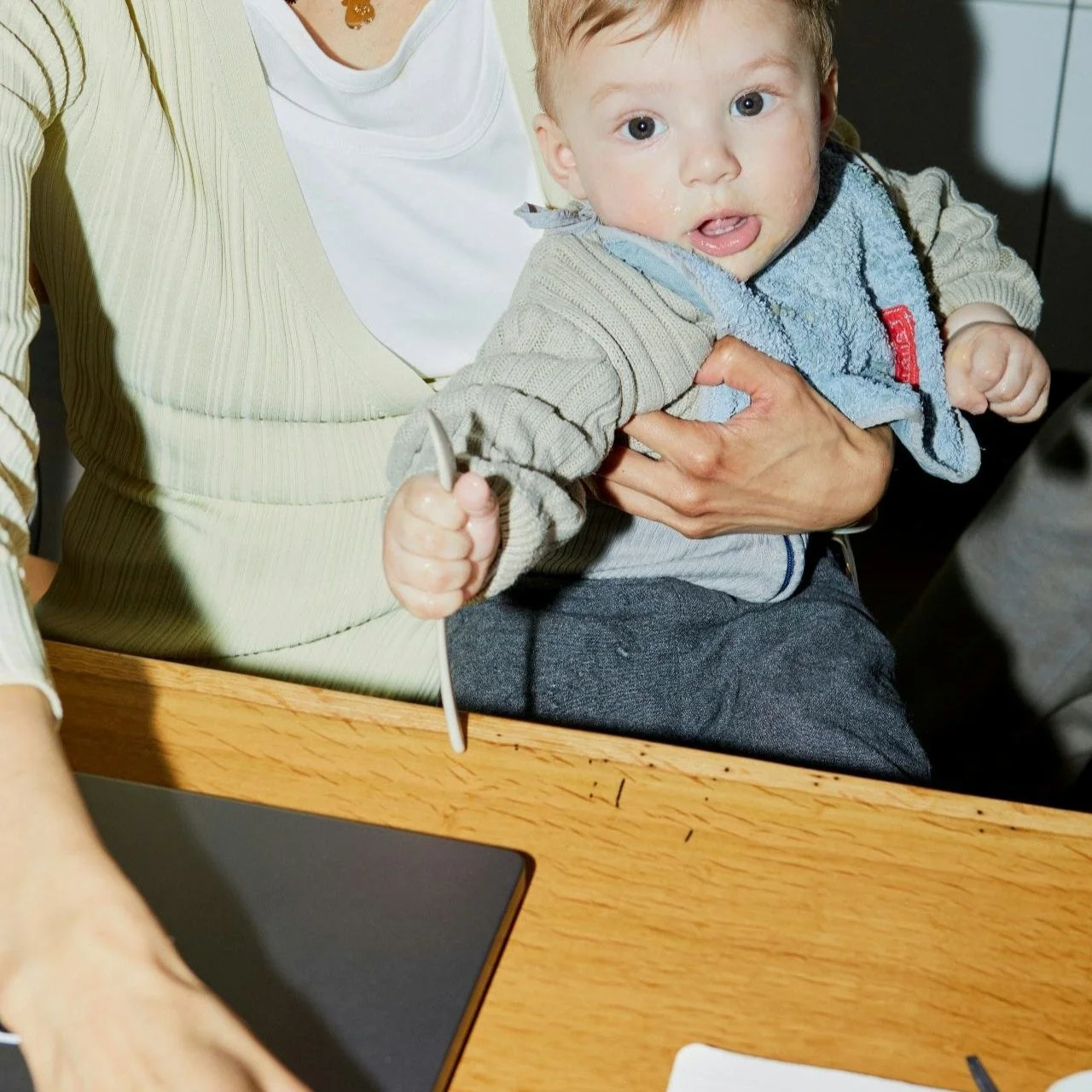 A mother holding her newborn at home