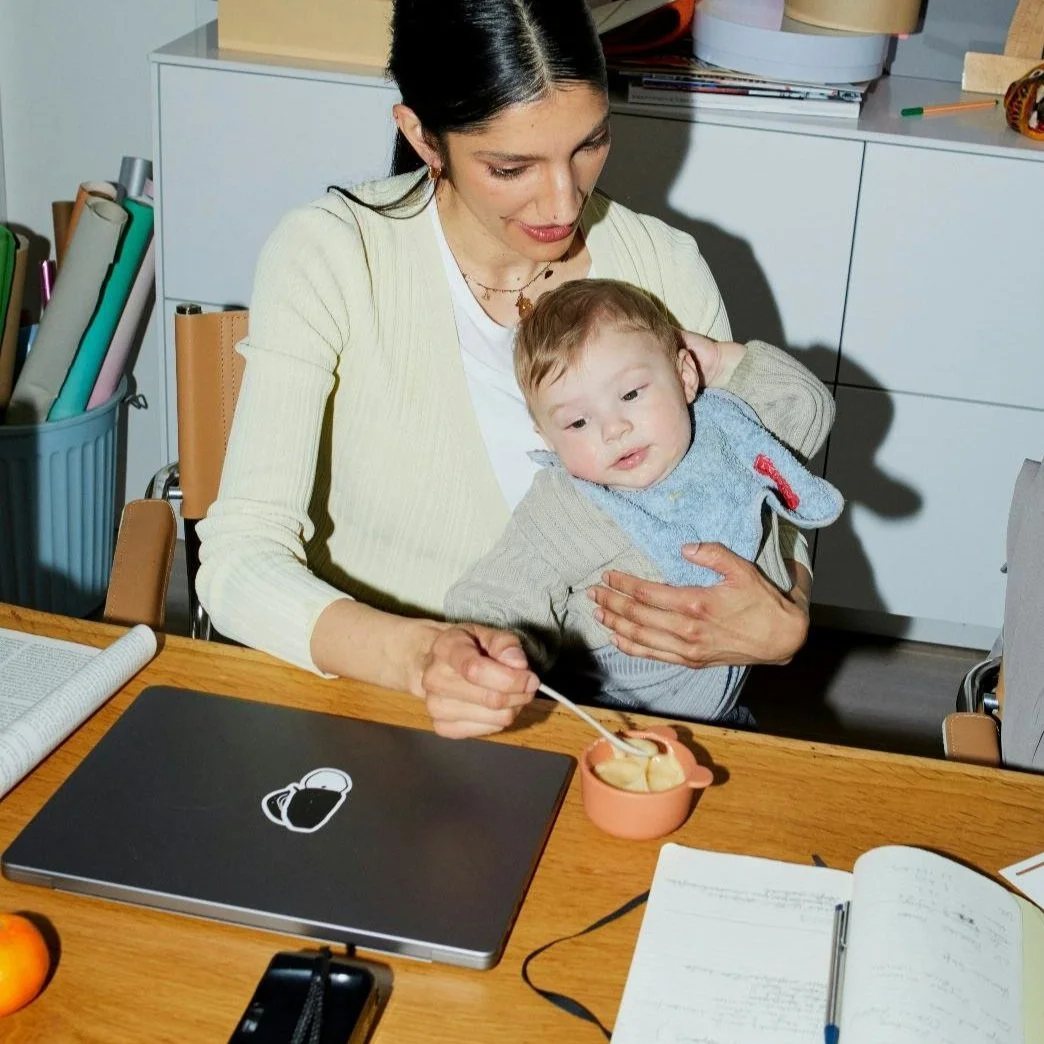 A mother working at home with her baby